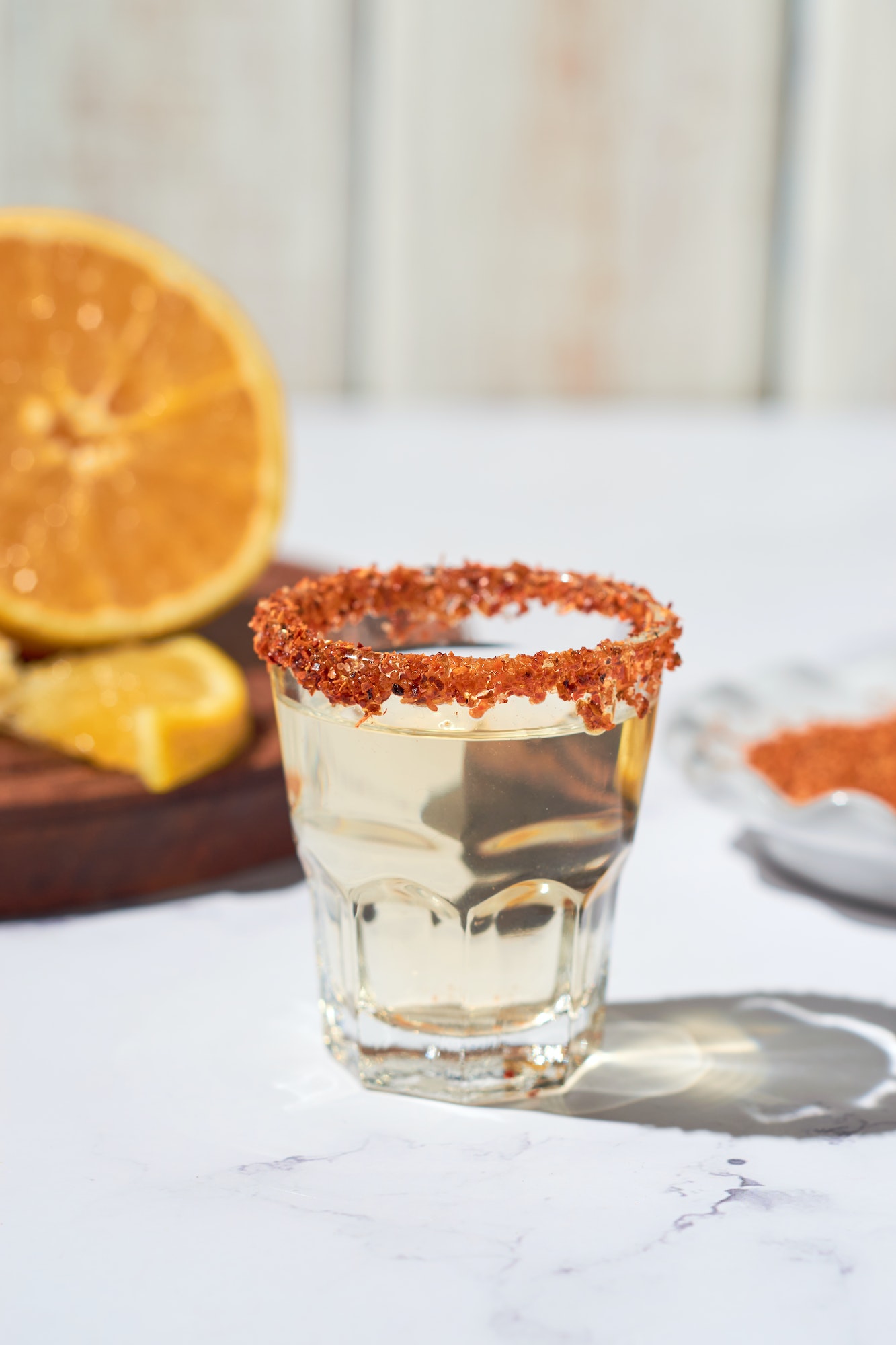 Mexican mezcal shots with slice of orange fruit and chili